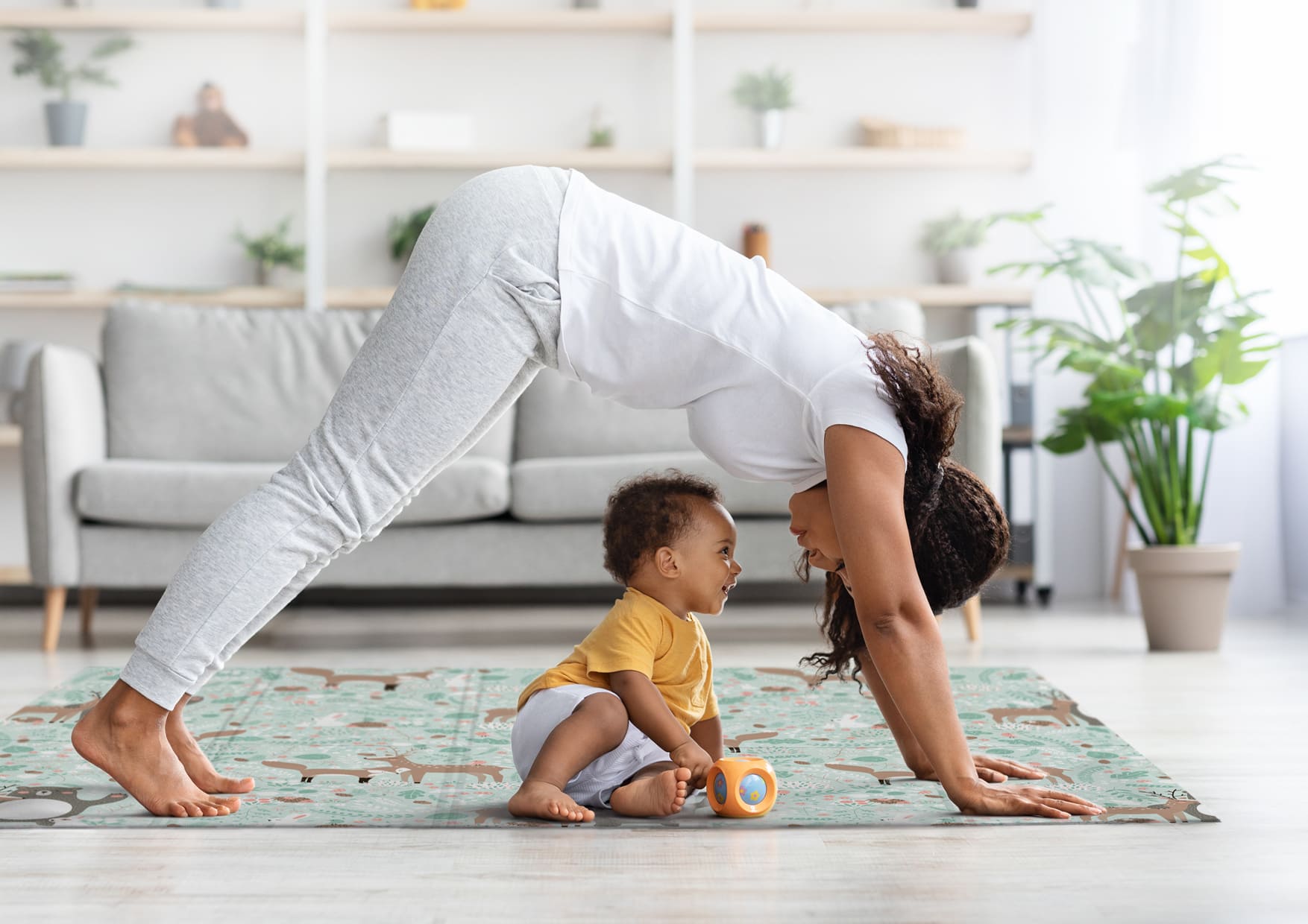 woman playing on a mat with a child
