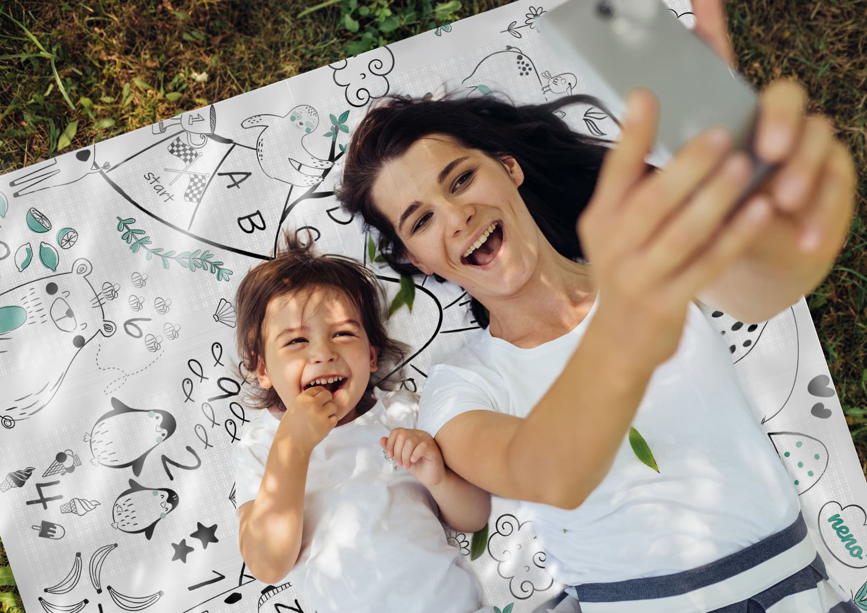 a child and a woman lying on a mat